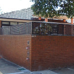 Brick and timber lattice used together make a light and secure fence.